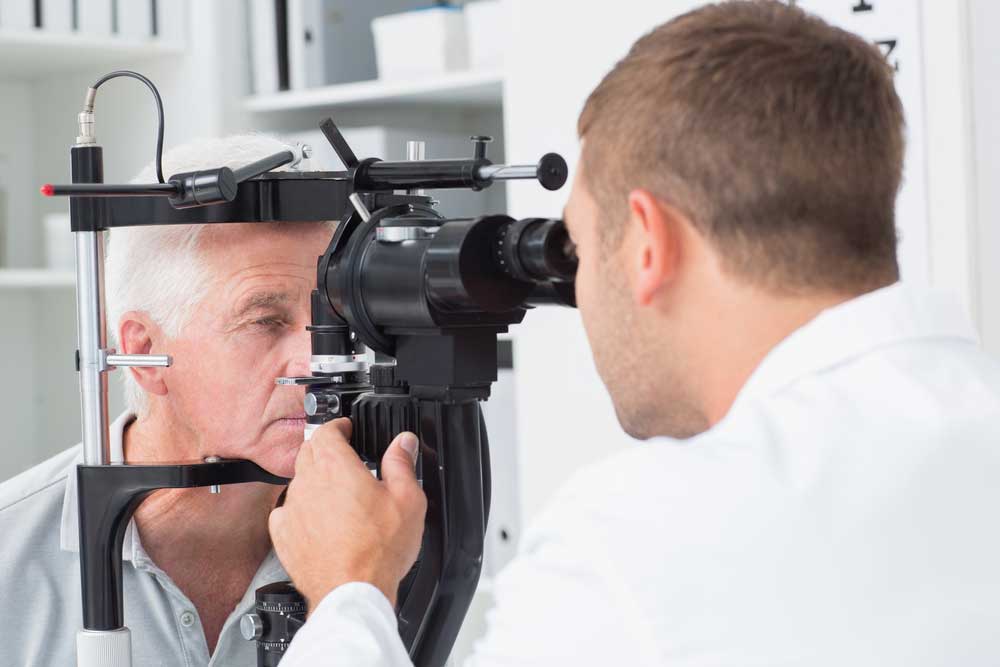 Older Gentleman Getting Eye Exam By An Ophthalmologist - Get the 3 Best Tupelo Medicare Medicare Plans Explained By Agape Insurance And Financial Group, A Top Rated Tupelo Medicare Agency
