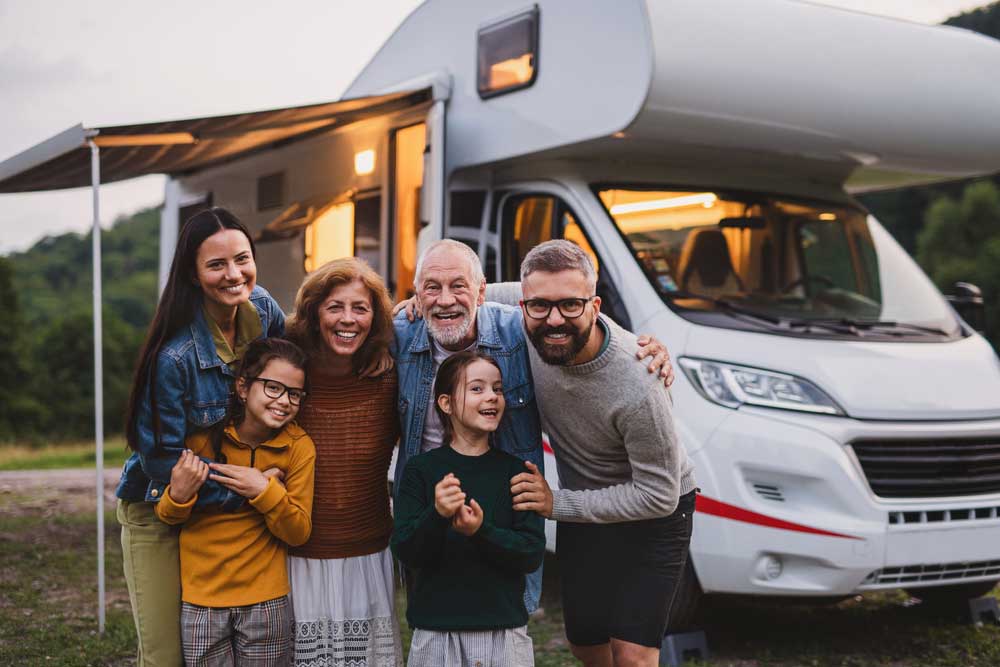 Smiling Family Group Picture In Front Of RV - Agape insurance And Financial Group In Tupelo, Mississippi, Can Help You And Your Family Plan For Your Future With Our Health insurance Plans, Medicare, Financial Services, Life Insurance, and more
